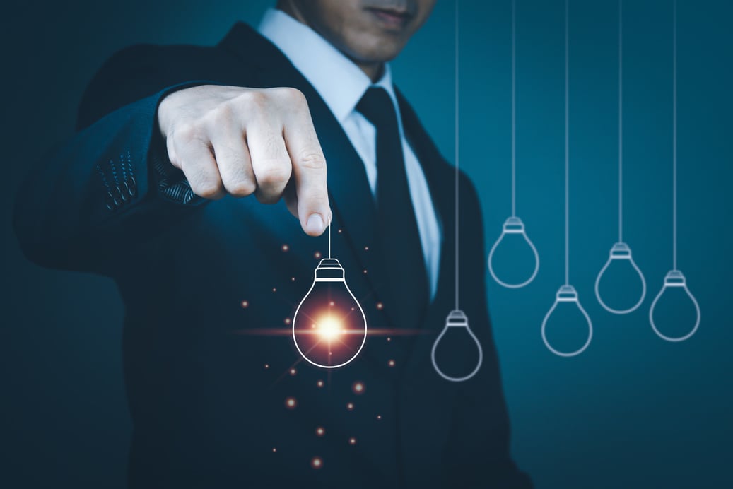 Man's Hand Wearing a Suit with a Lightbulb